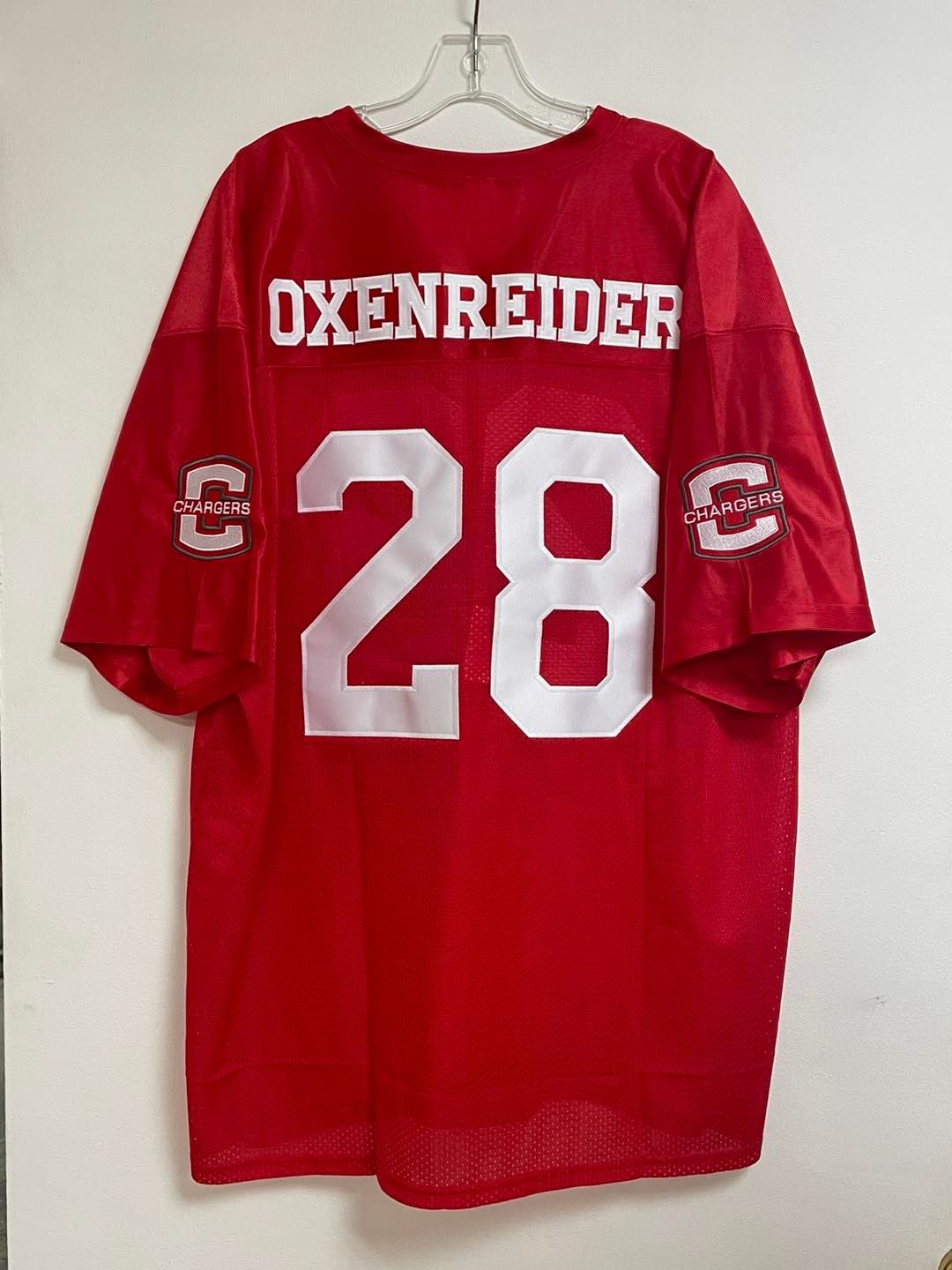 A red oxenreider jersey is hanging on a hanger
