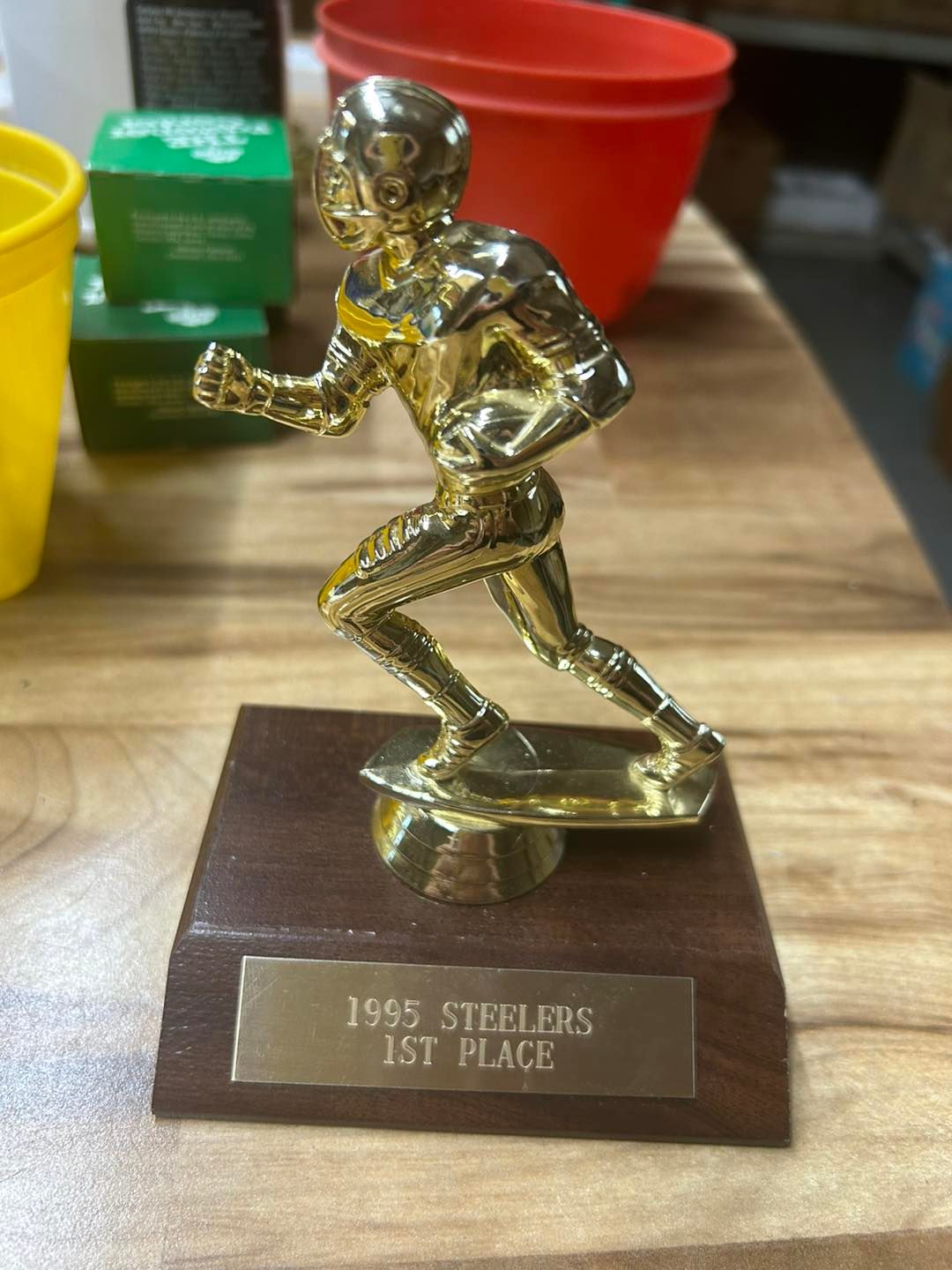 A trophy that says ' 1955 steelers 1st place ' on it