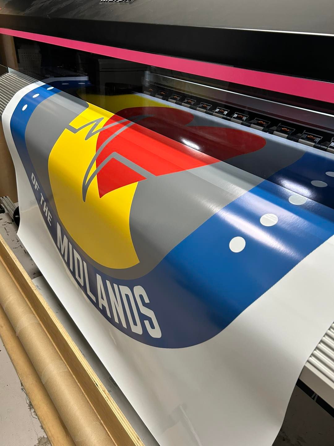 A sign that says midlands is being printed on a machine