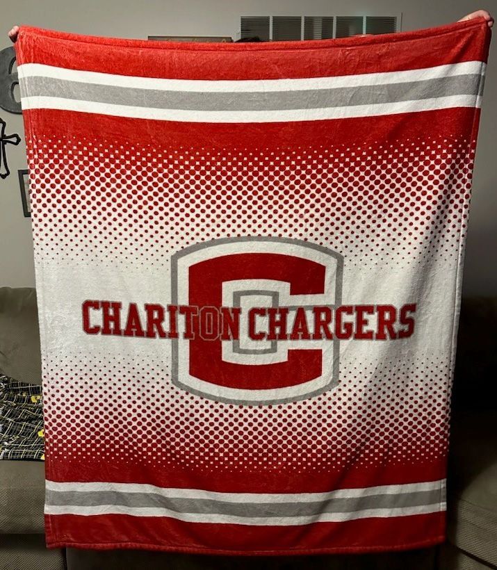 A red and white blanket with the word chariton chargers on it