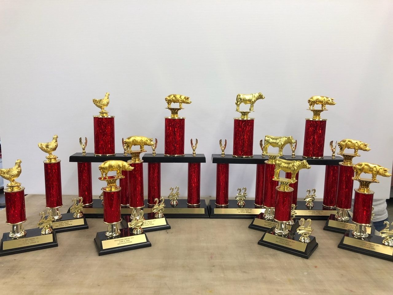A bunch of trophies with gold animals on them
