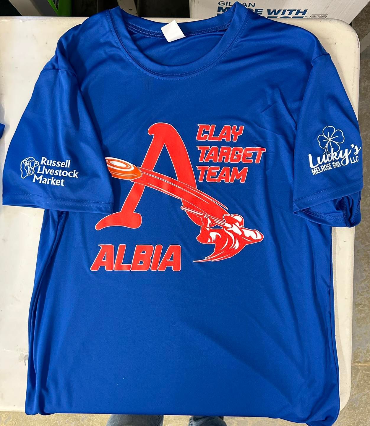 A blue shirt that says clay target team on it