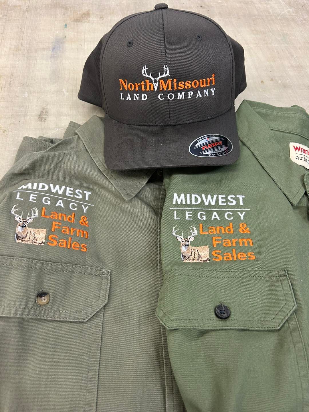 A north missouri land company hat and a midwest legacy land & farm sales shirt