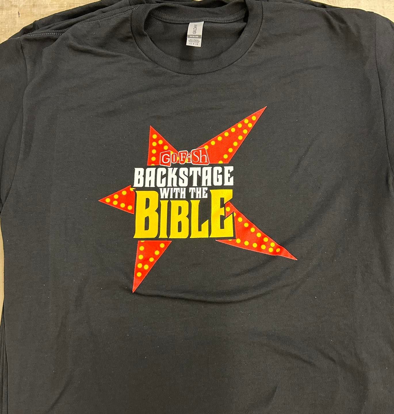 A black t-shirt that says backstage with the bible