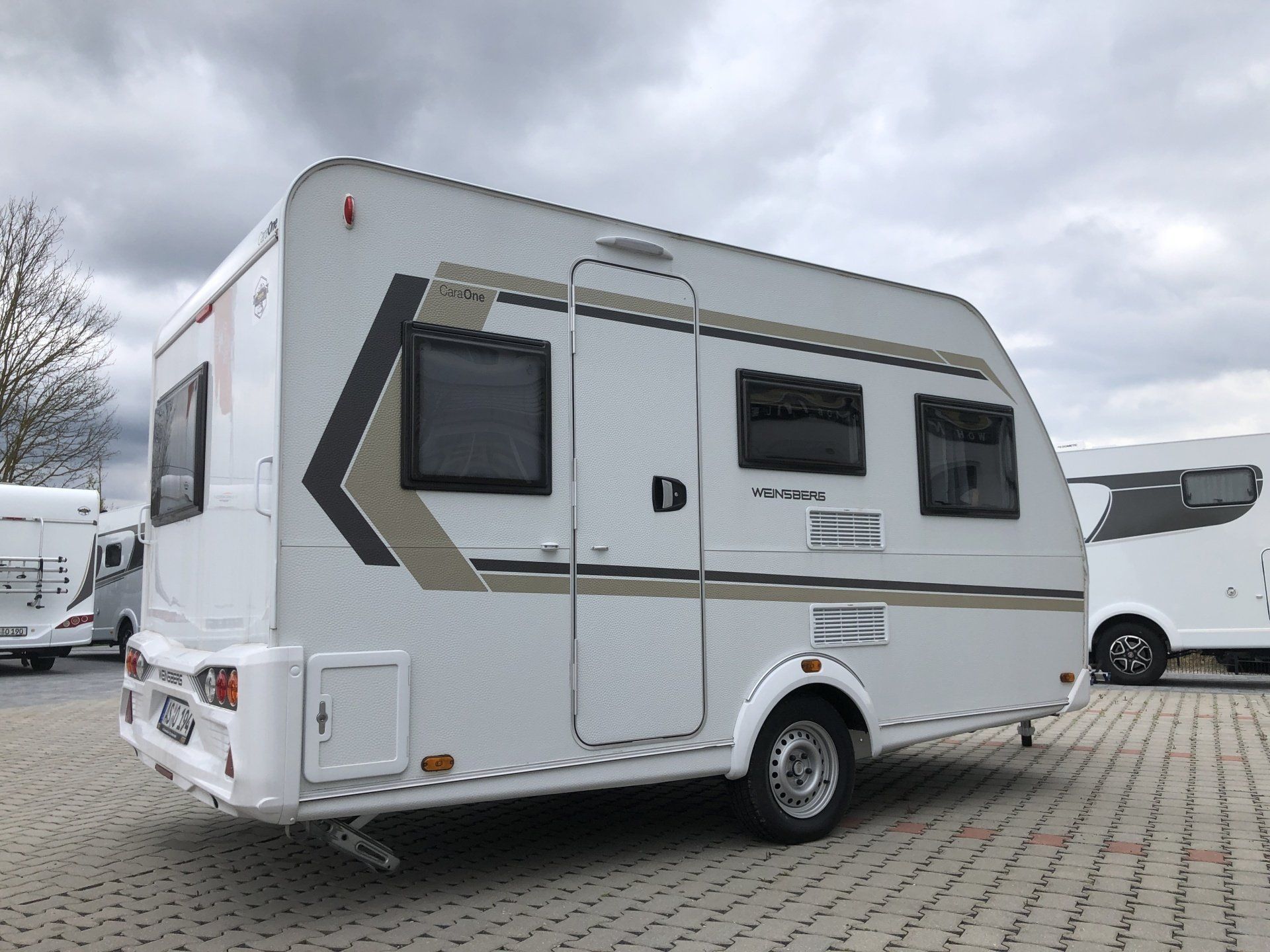 A white rv is parked in a parking lot.
