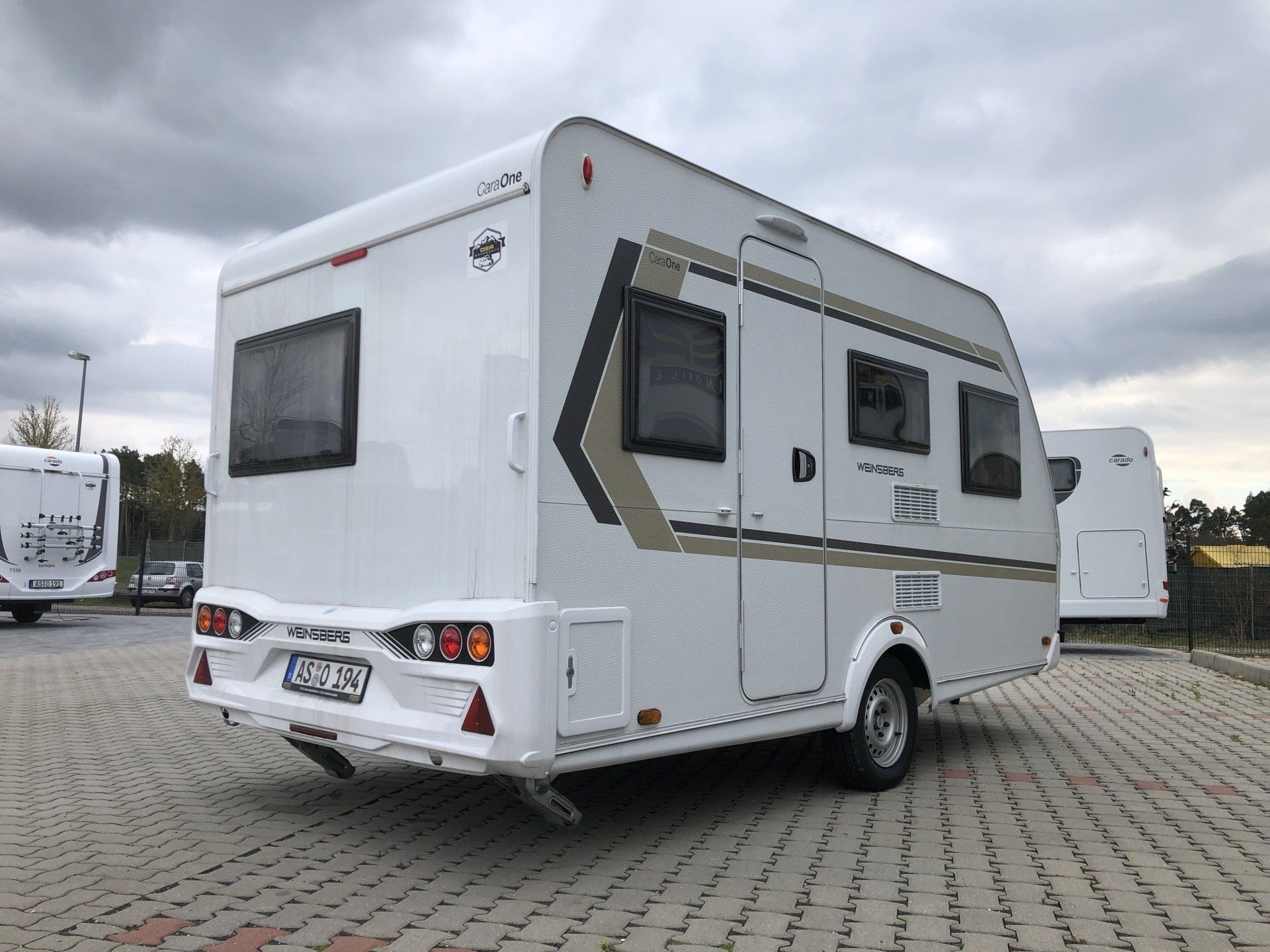 A white rv is parked in a parking lot.