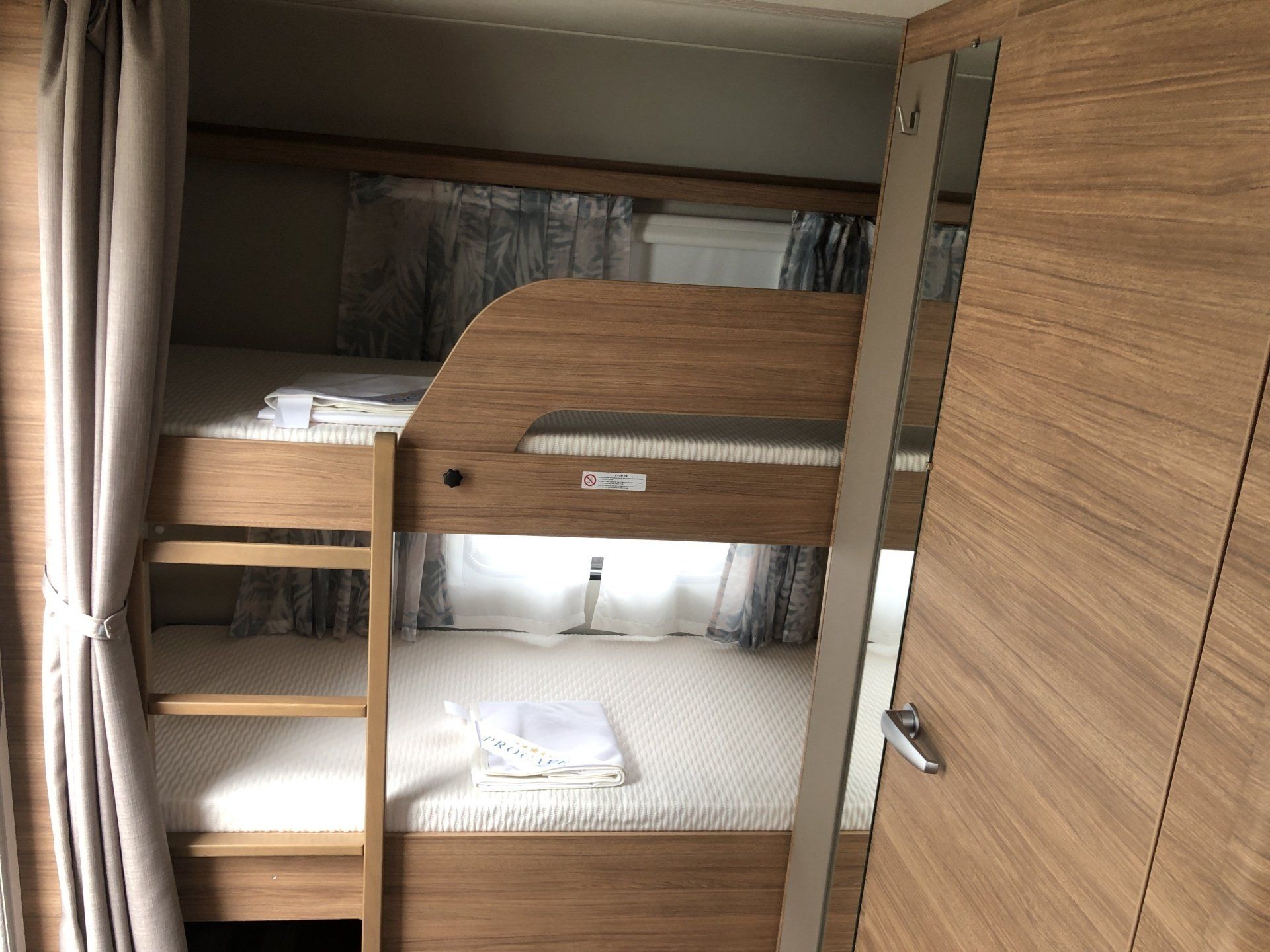 There is a bunk bed in the corner of the room.