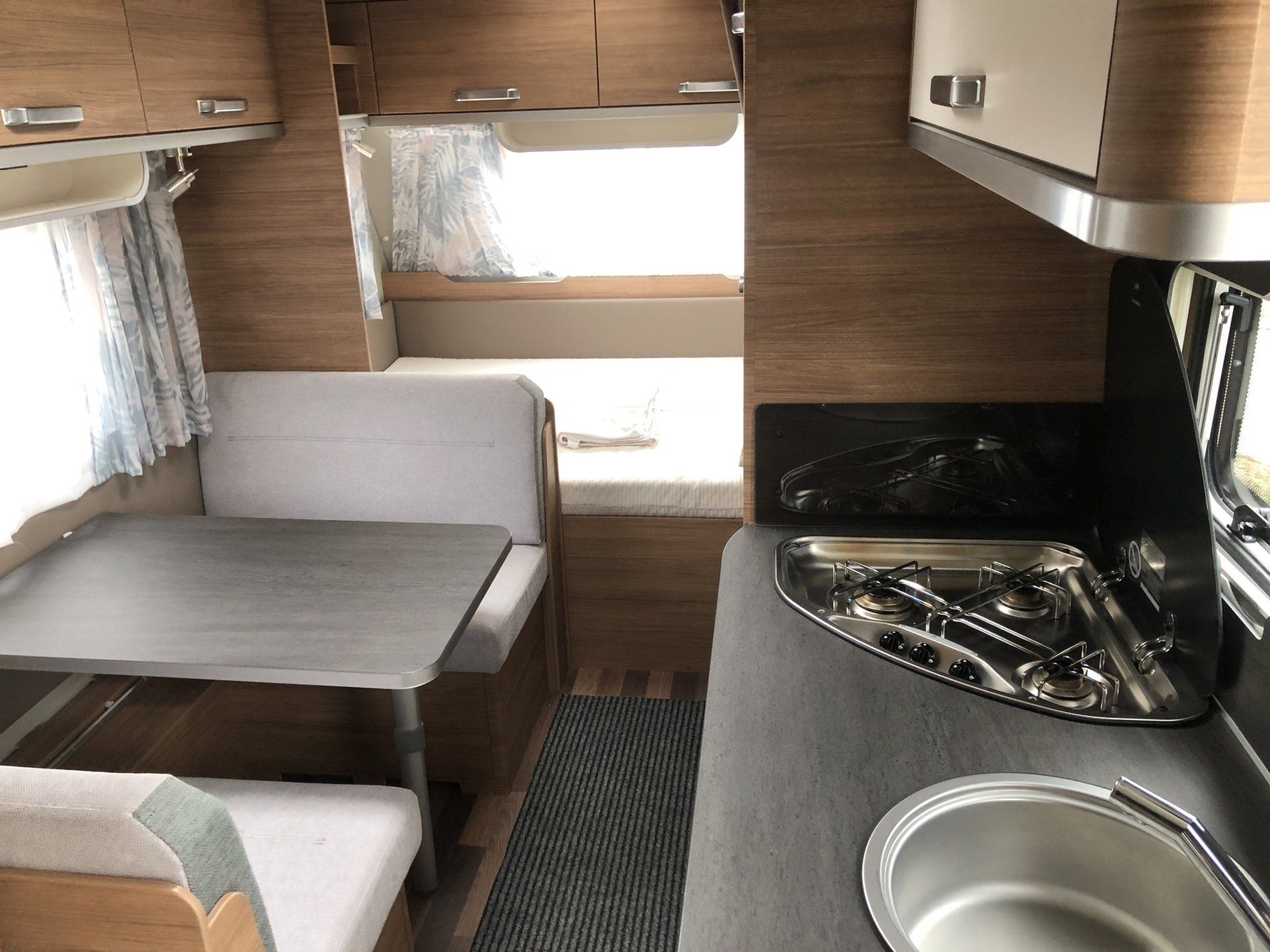 The inside of a camper with a table and a sink
