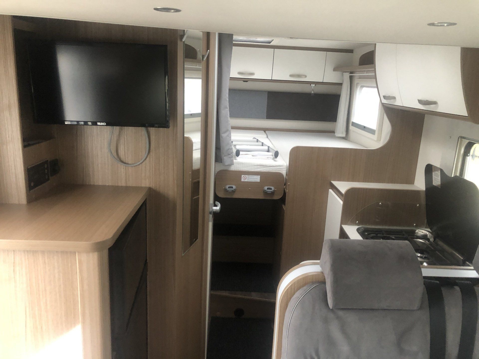 The inside of a camper van with a flat screen tv