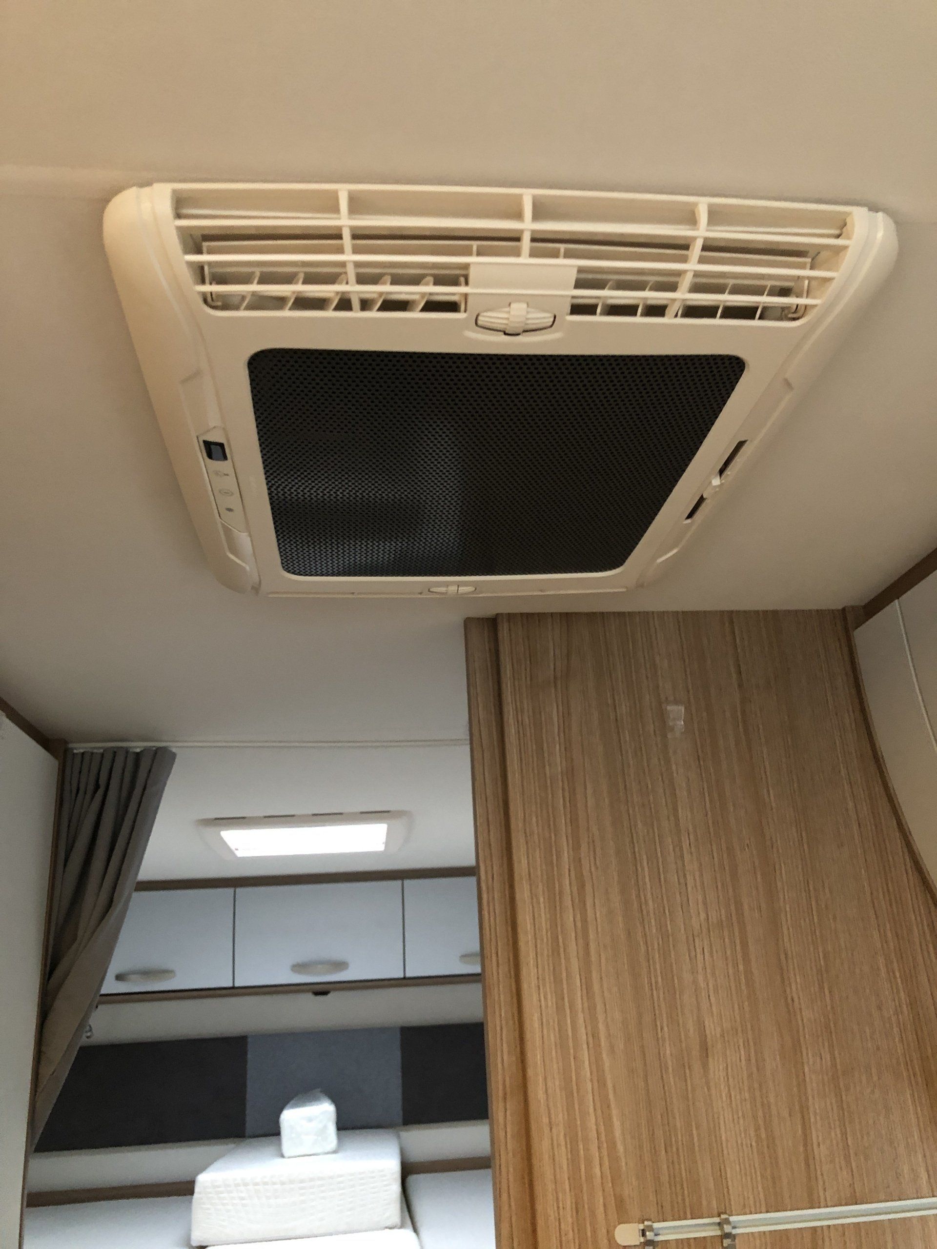 A ceiling fan is hanging from the ceiling of a camper.