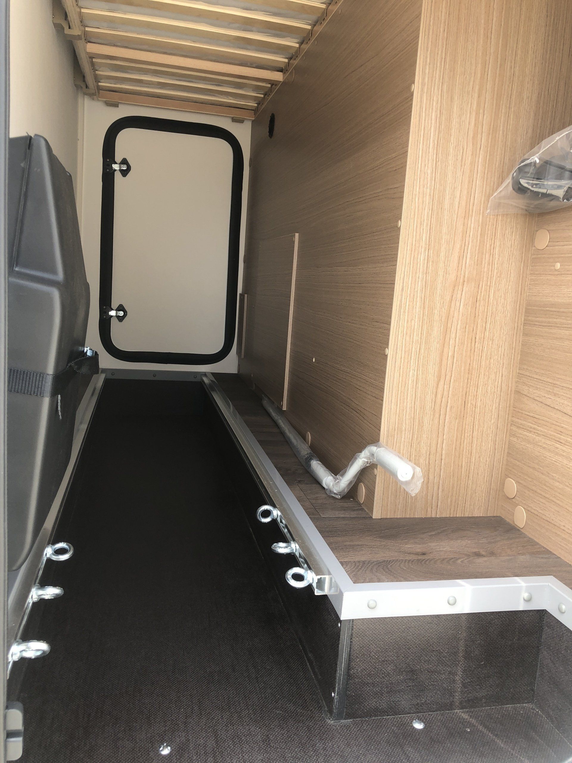 The inside of a truck with a door and stairs