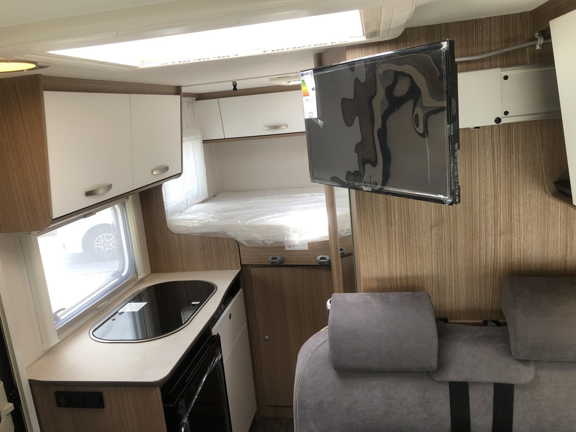 A camper van with a flat screen tv mounted on the wall.