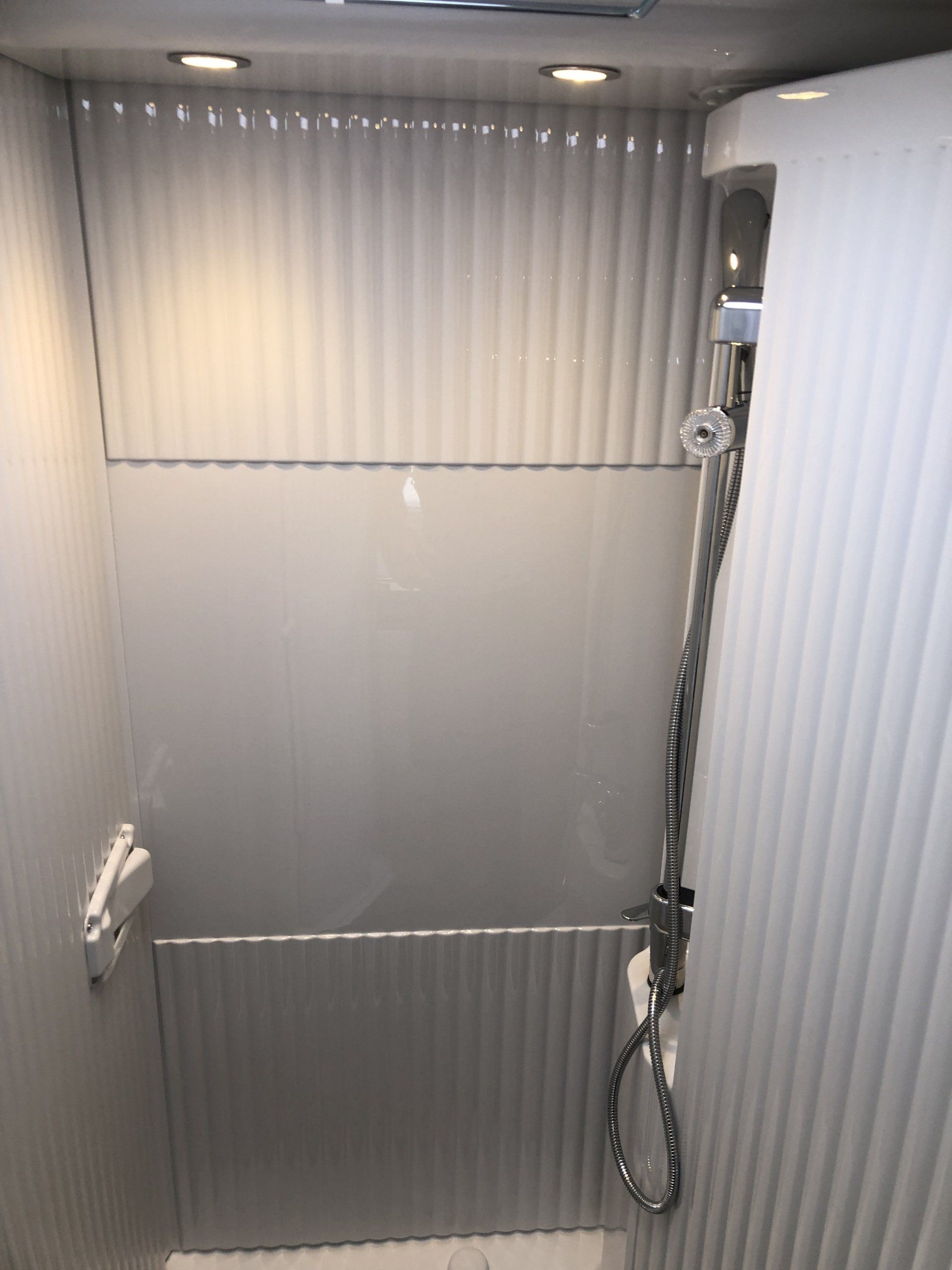 A bathroom with a shower and a toilet in it