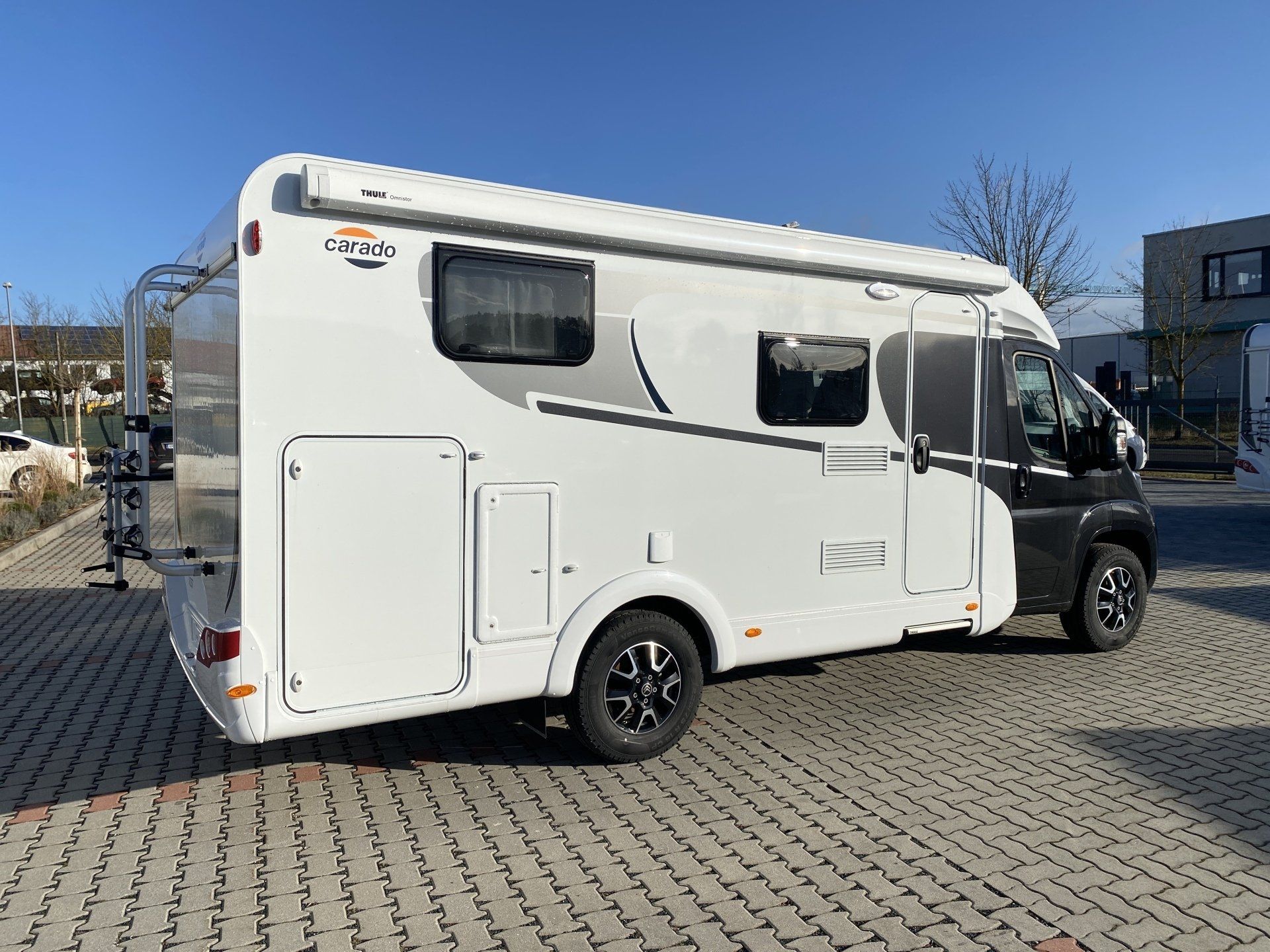 A white rv is parked in a parking lot.