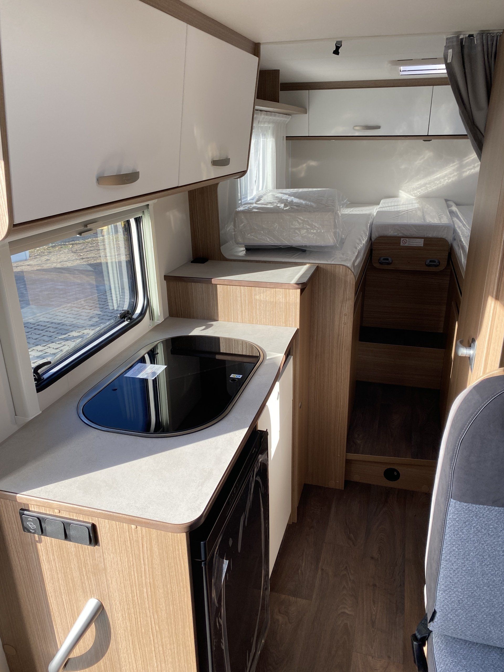 A kitchen in a camper van with a sink and stove.