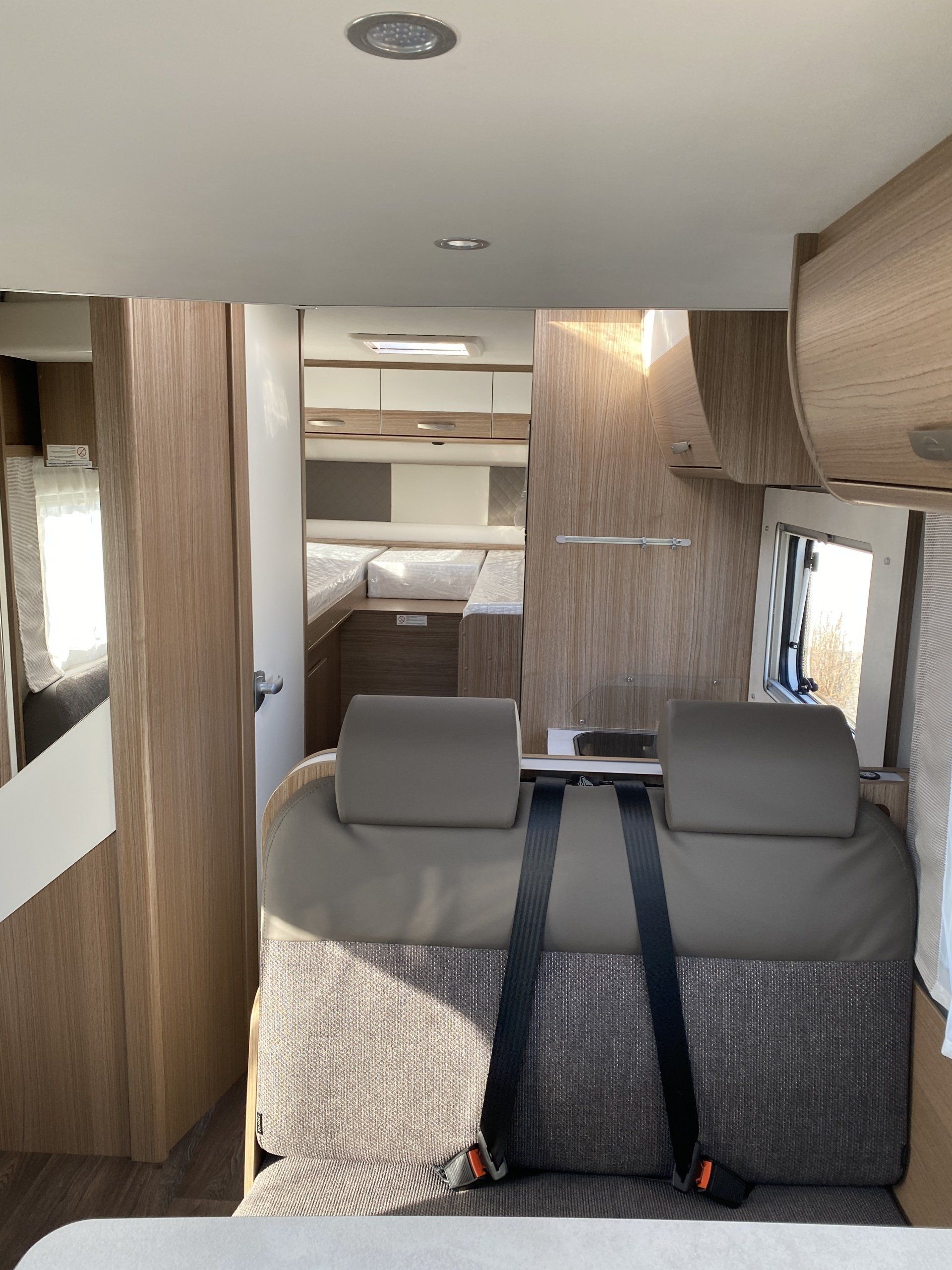 The back seat of a camper van with a seat belt on it.