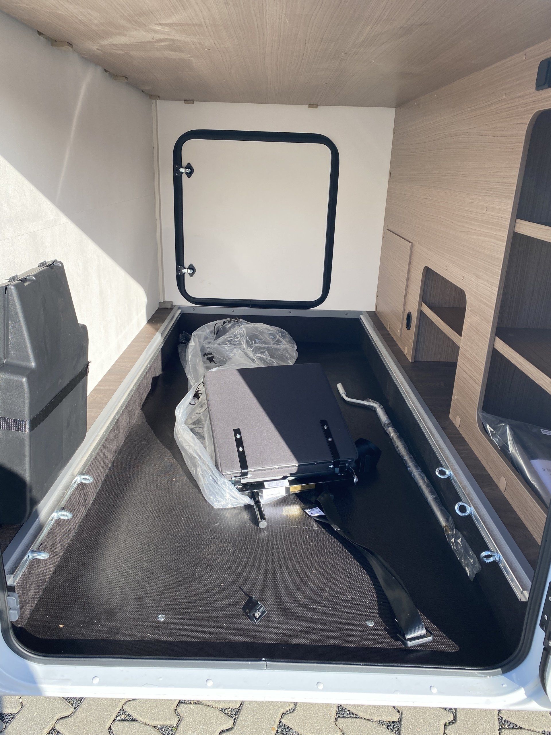 The inside of a camper with a motorcycle in it