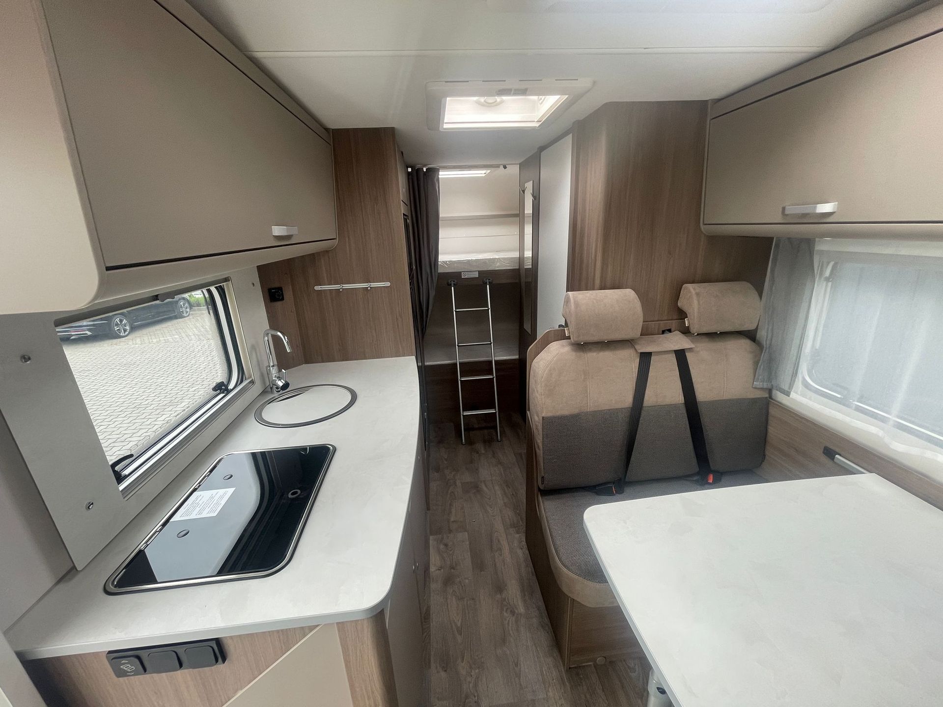 Eine Küche im Wohnmobil mit Spüle, Herd und Tisch.