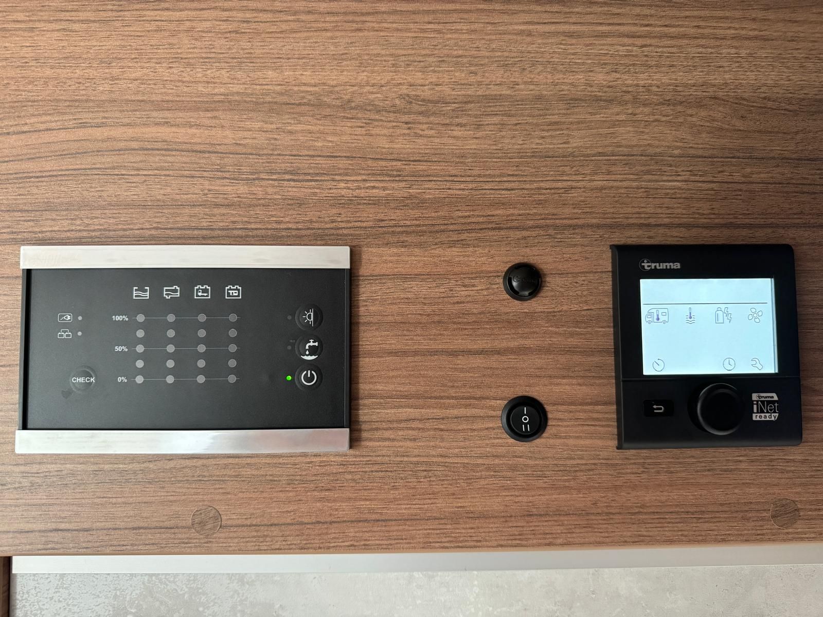 Eine Nahaufnahme eines Thermostats an einer Holzwand.