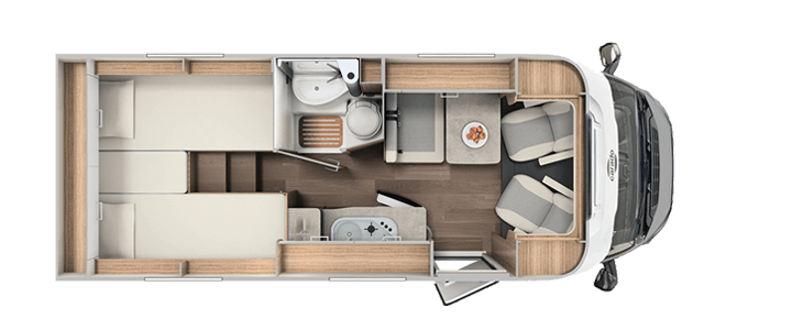 Ein Grundriss eines Wohnmobils mit Bett, Toilette, Waschbecken und Stühlen.