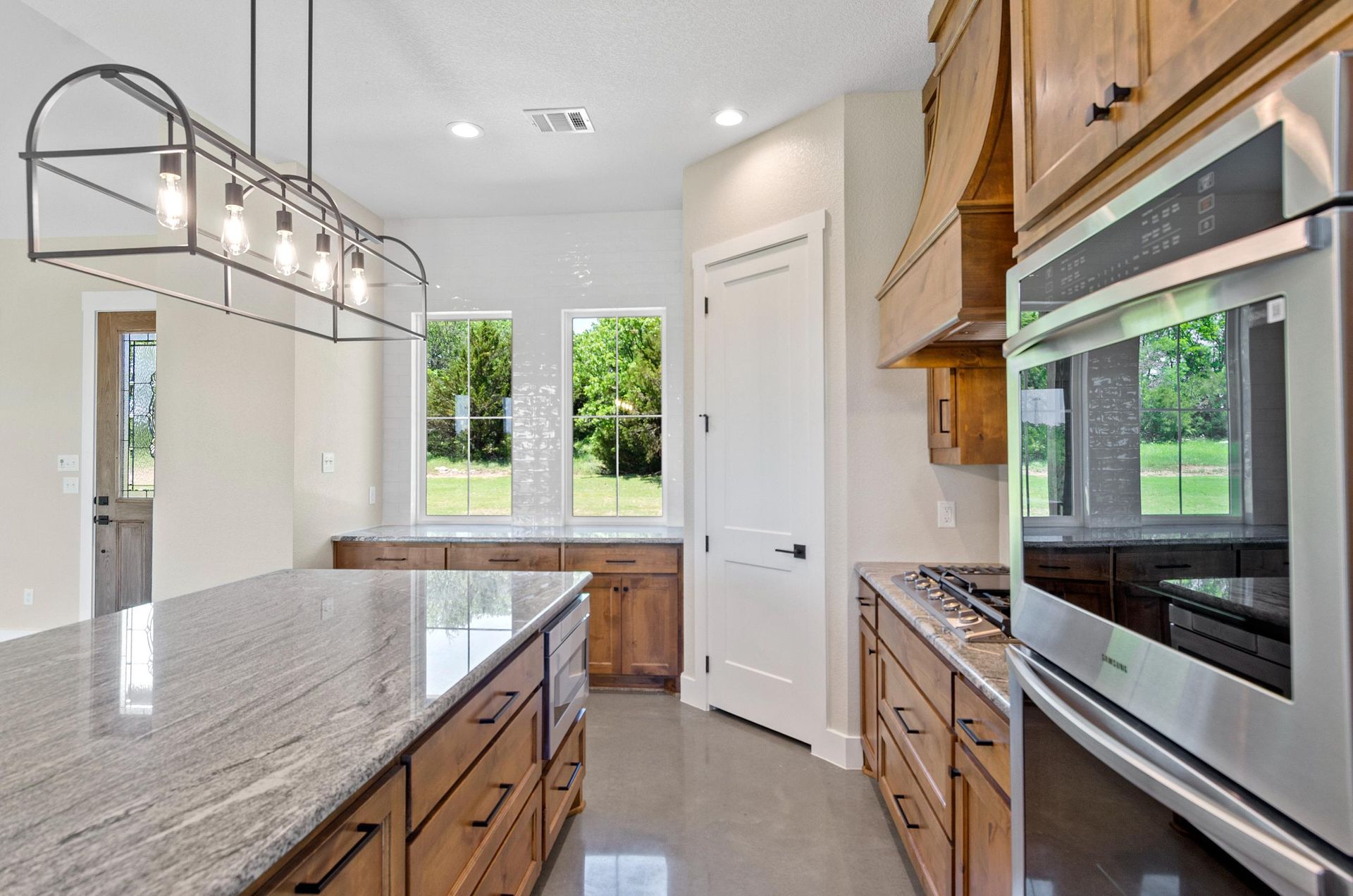 A kitchen with stainless steel appliances and granite countertops.