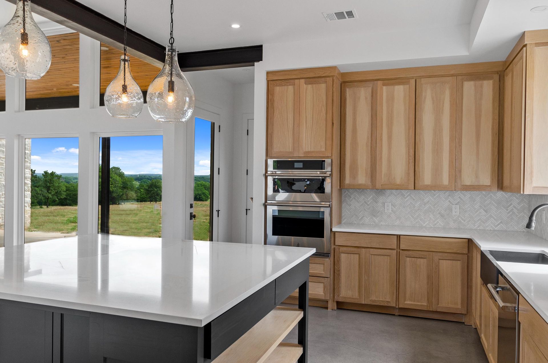 A kitchen with wooden cabinets and white countertops.
