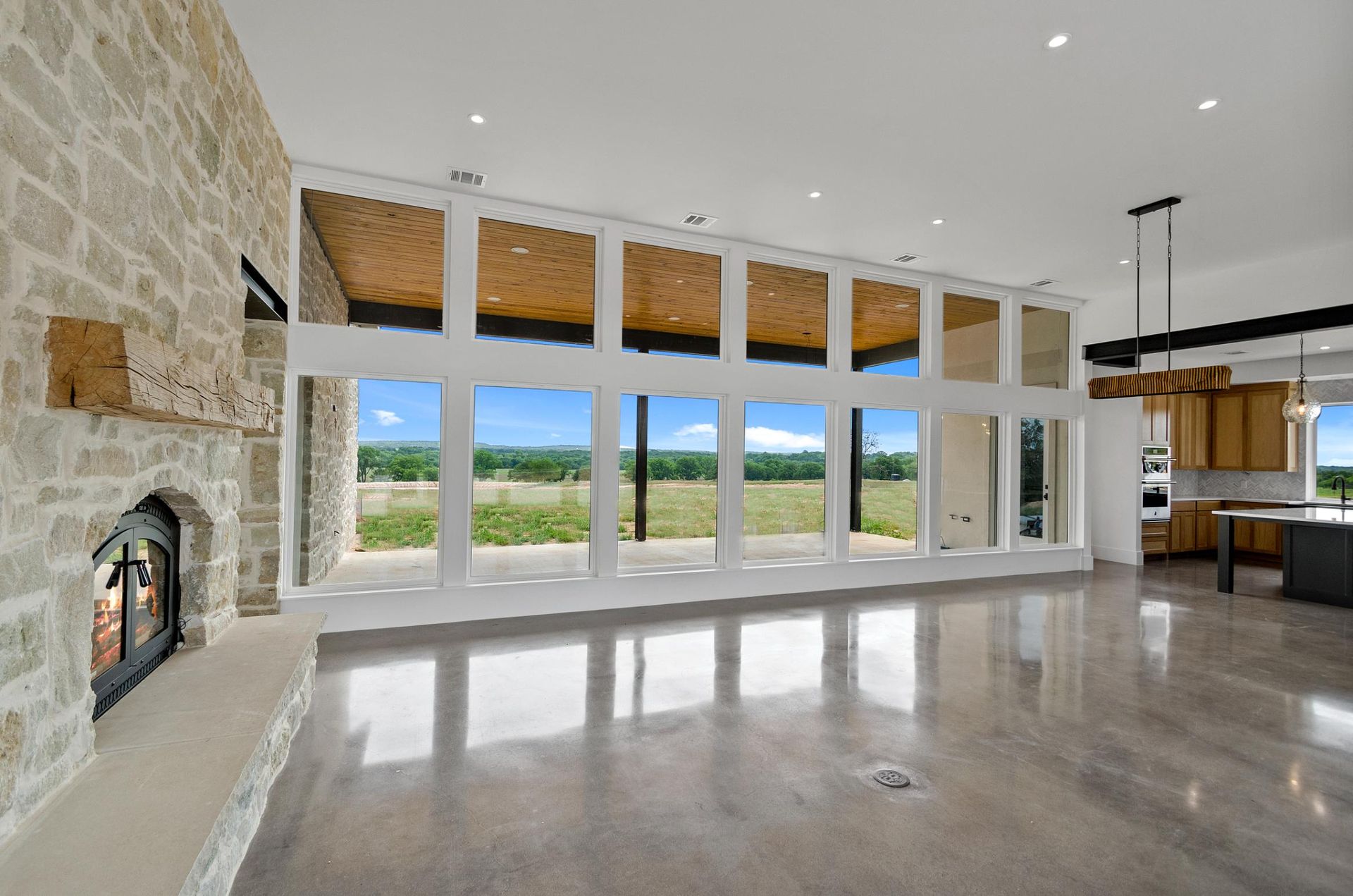 A living room with a fireplace and a lot of windows