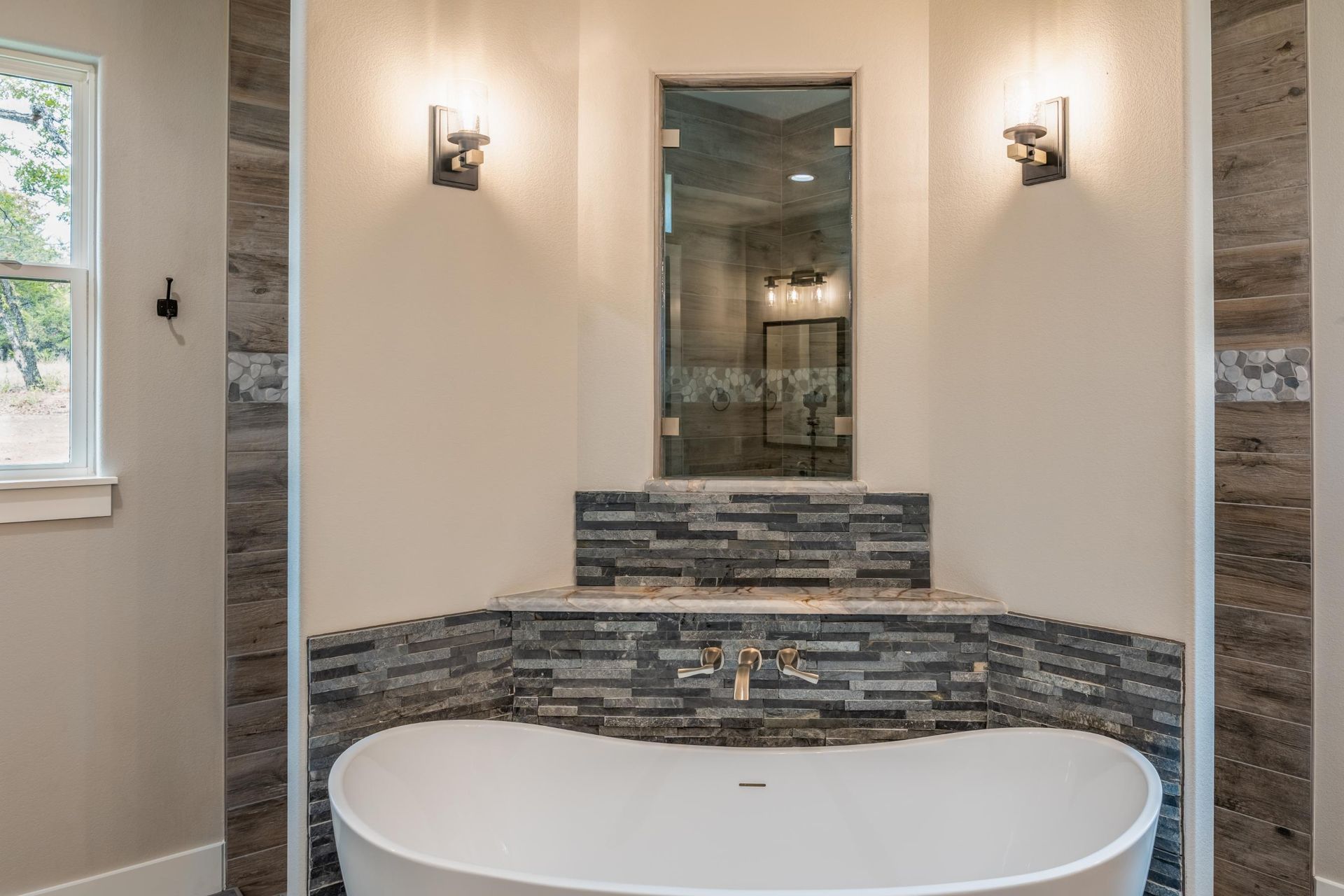 A bathtub in the middle of the bathroom.