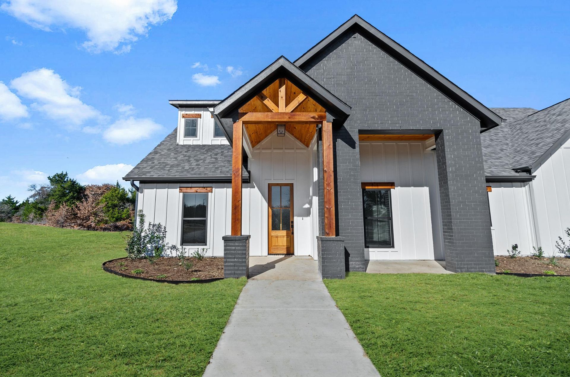 A white and black house with a porch.