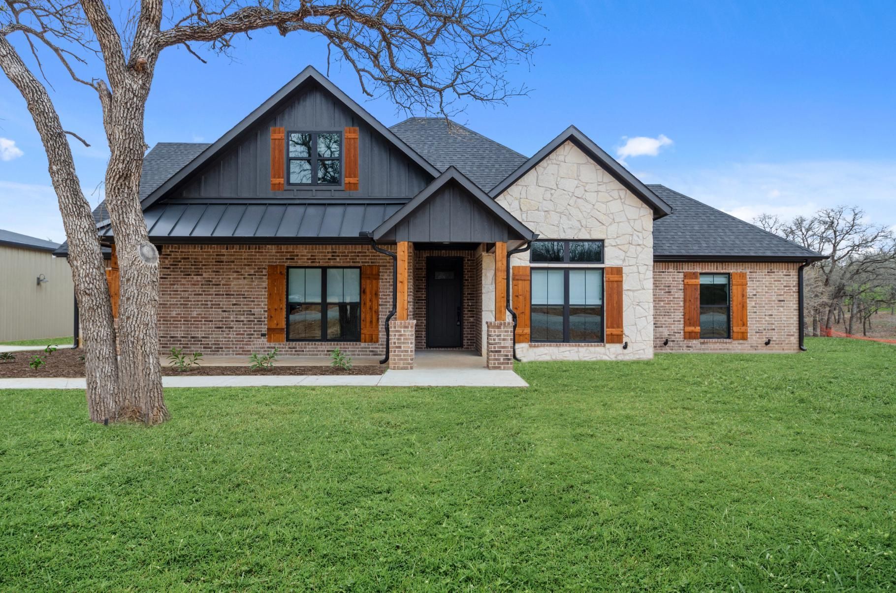 A large brick house with a metal roof.