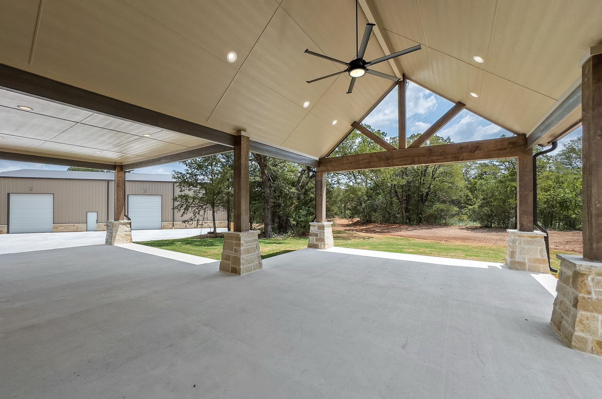 There is a ceiling fan hanging from the ceiling of the pavilion.