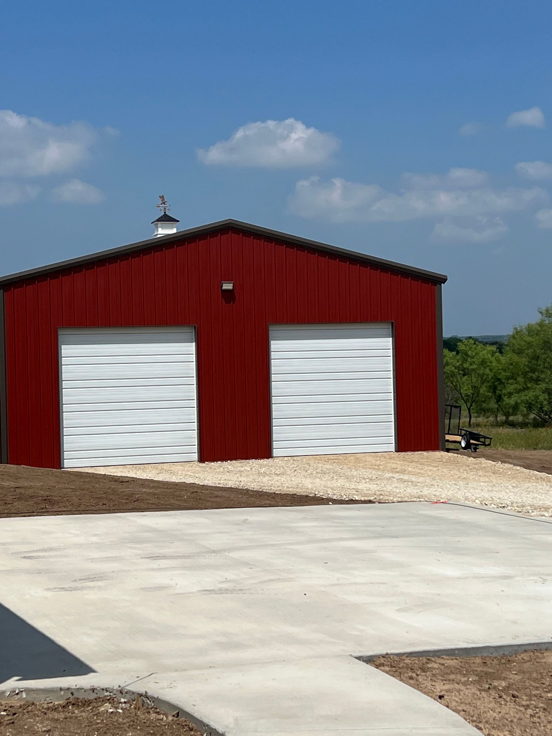 A red garage with two white garage doors.