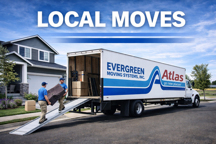 Local movers loading furniture into an Evergreen Moving Systems Atlas truck on a suburban street