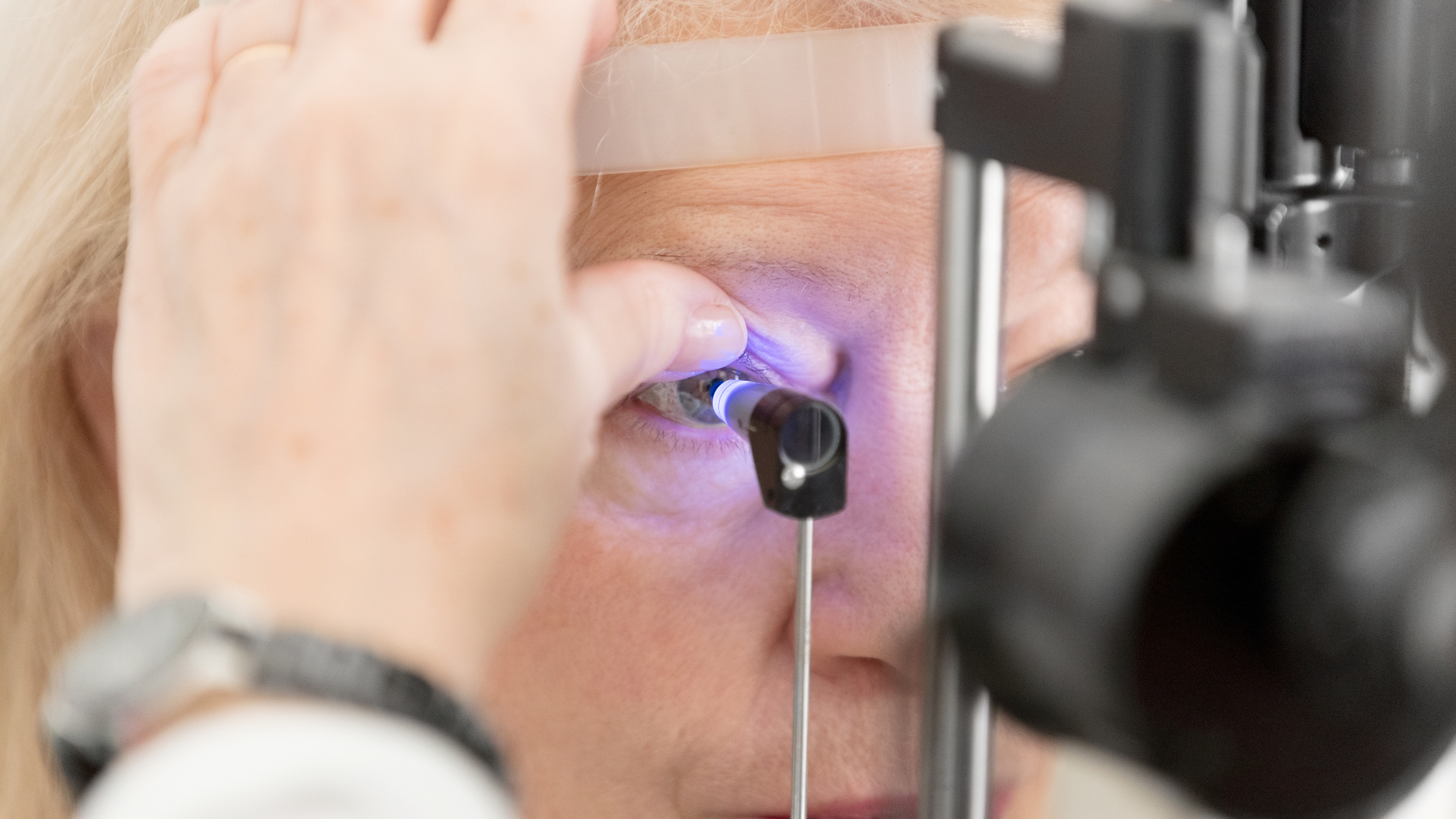 Close-up of an eye exam with a patient looking into a retinal imaging device