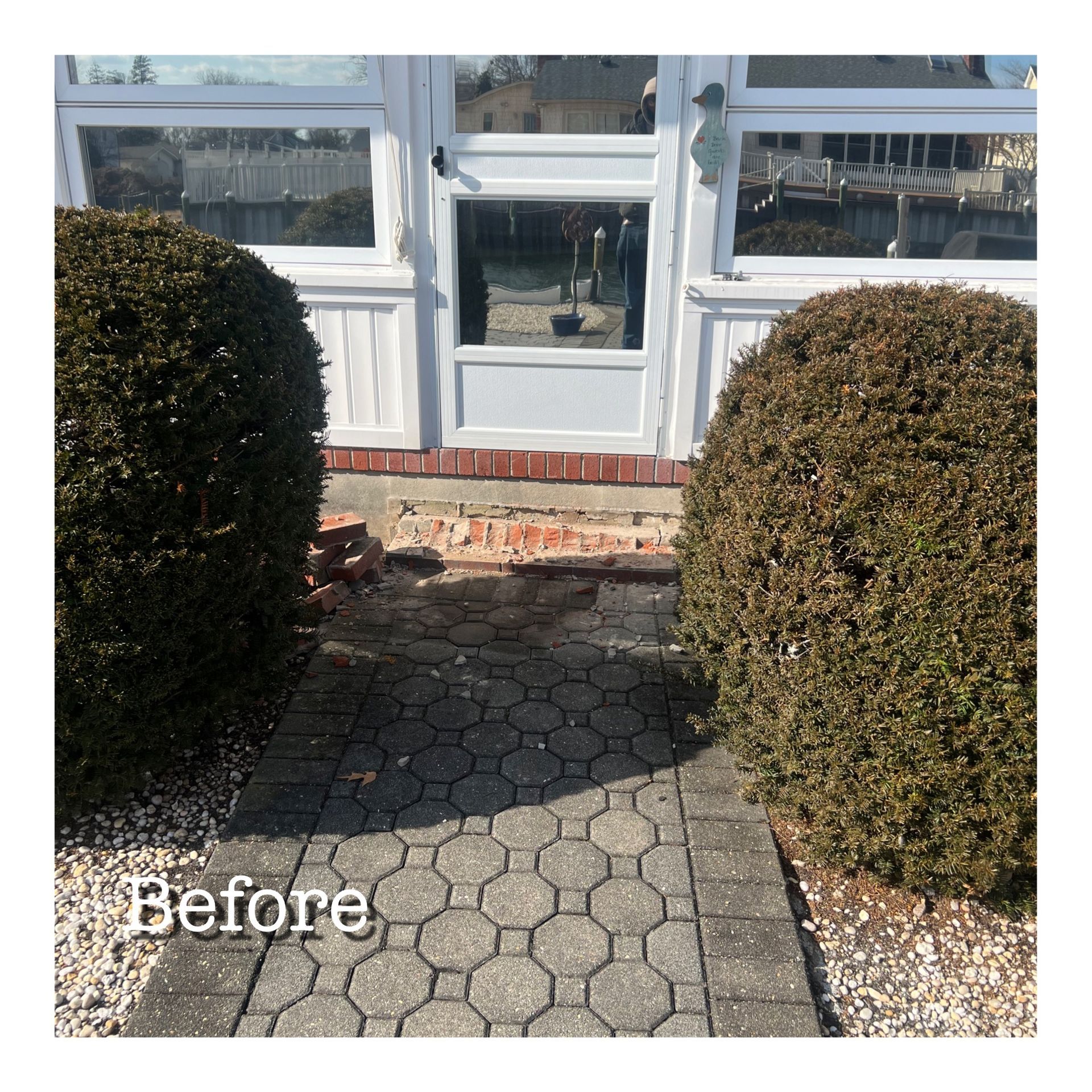 A before picture of a walkway leading to a door