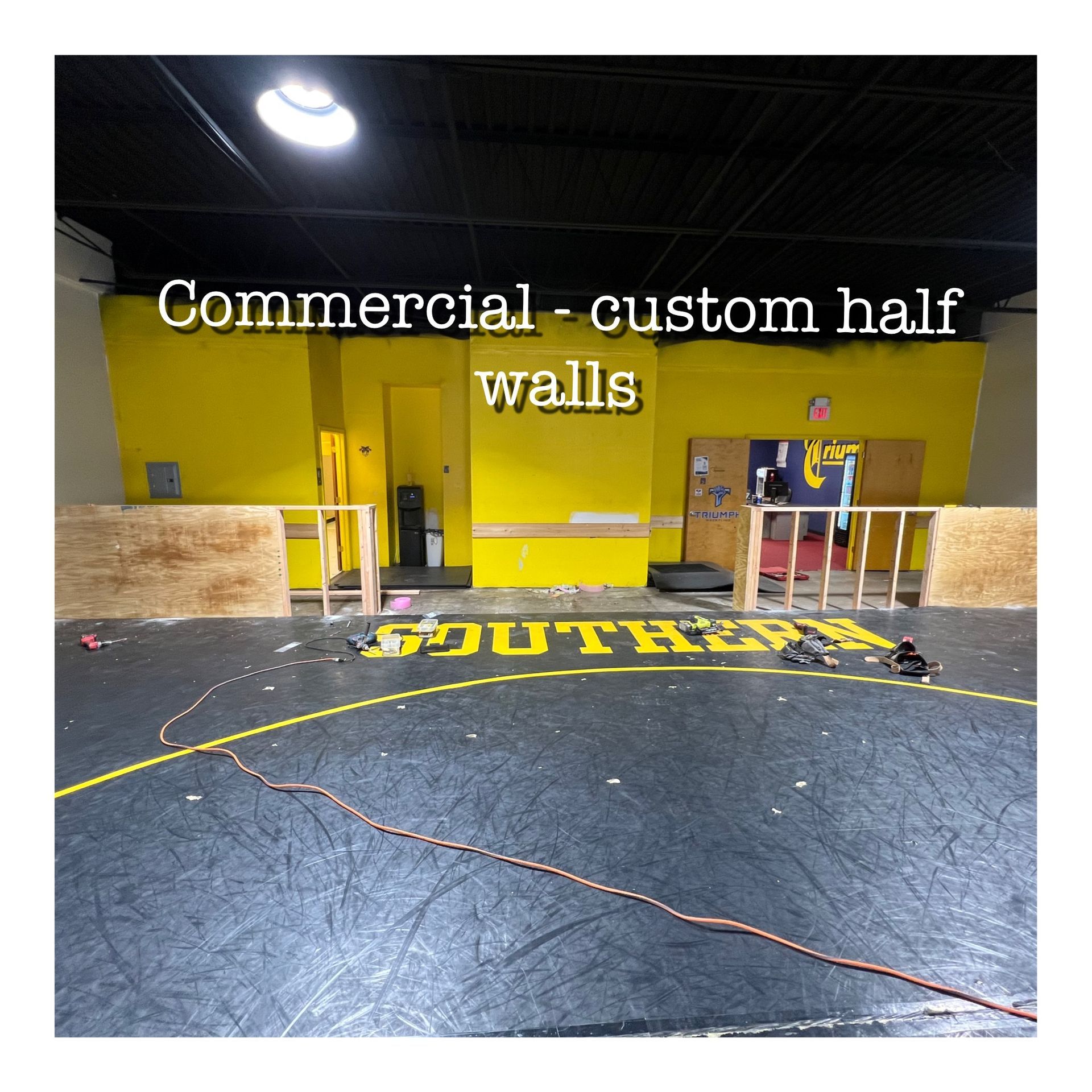 A picture of a gym with the words commercial custom half walls on it