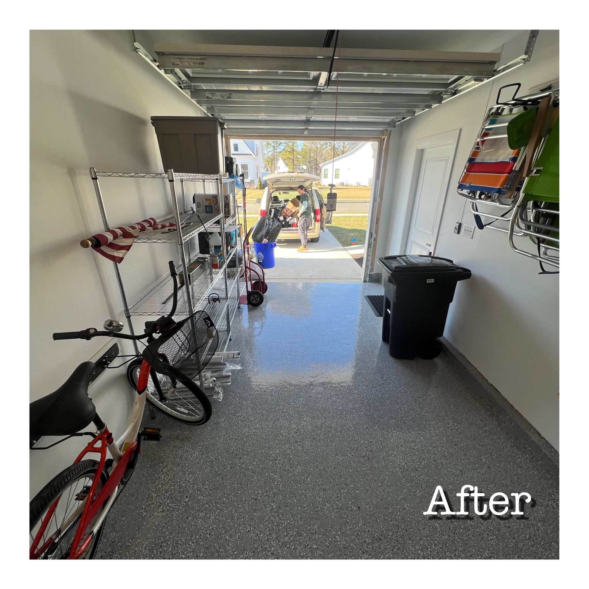 A bicycle is parked in a garage with the door open.