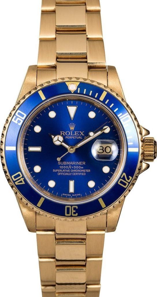 Gold Rolex watch with blue bezel and dial, showing the date at 3 o’clock.