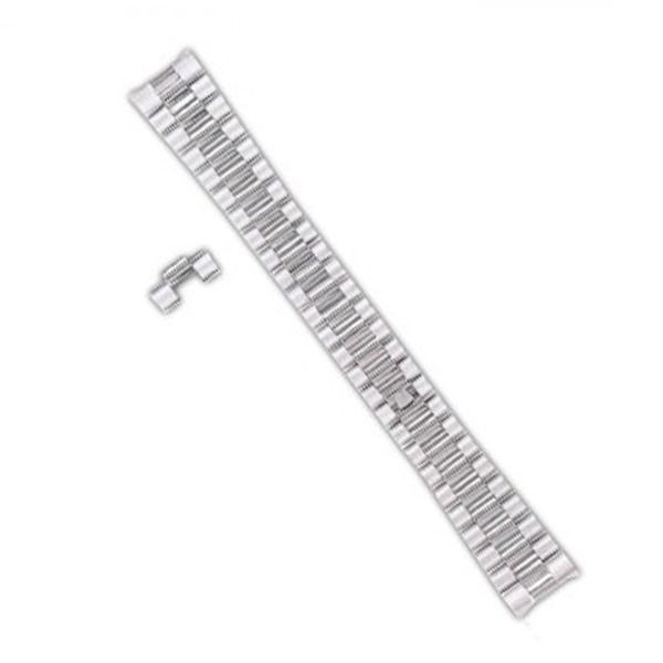 Silver metal watch band with an extra link on a white background