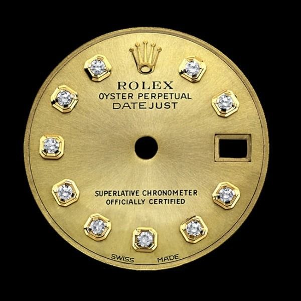 Gold Rolex Oyster Perpetual Datejust watch dial with diamond markers and date window