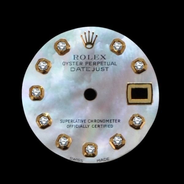 Rolex Oyster Perpetual Datejust watch dial with diamond markers and black date window, pearl face