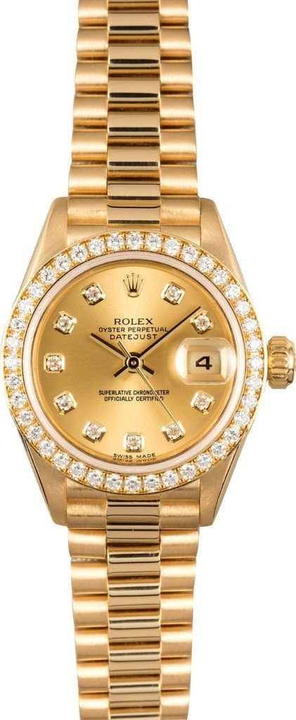 Gold wristwatch with a diamond bezel and date display on a metal bracelet