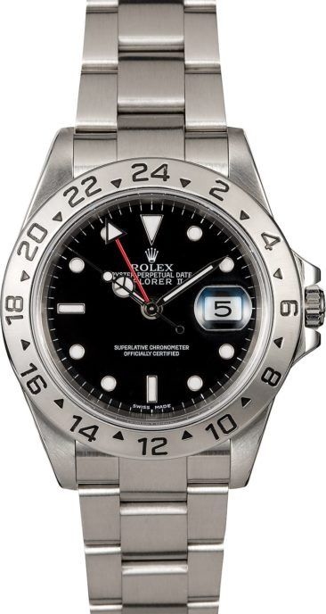 Silver Rolex watch with black dial, date window, and GMT bezel on a stainless steel bracelet