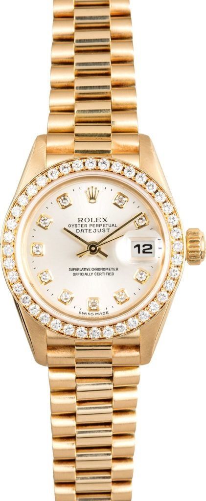 Gold Rolex-style wristwatch with diamond bezel and date display on a white background