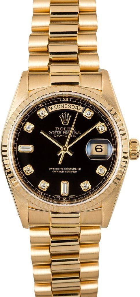 Gold wristwatch with black dial and date window