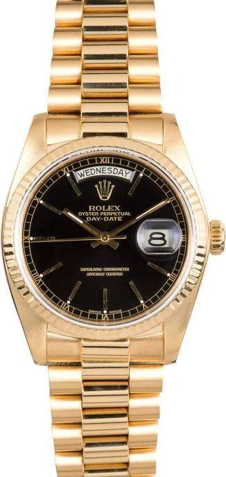 Gold Rolex wristwatch with black dial and date window on a gold metal band