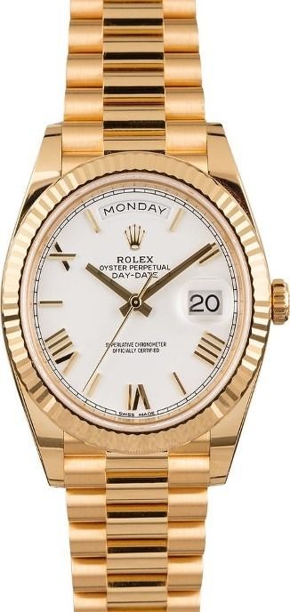 Gold Rolex watch with white dial and fluted bezel showing Monday and date 20