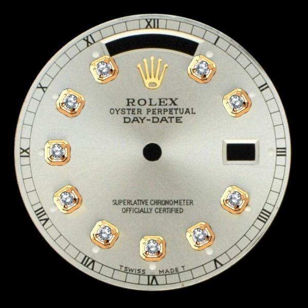 Rolex Day-Date watch dial with Roman numerals and diamond hour markers on a silver face