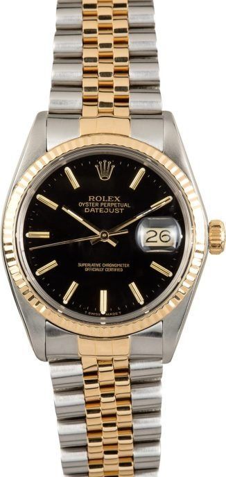 Two-tone Rolex wristwatch with black dial and date display on a silver and gold bracelet