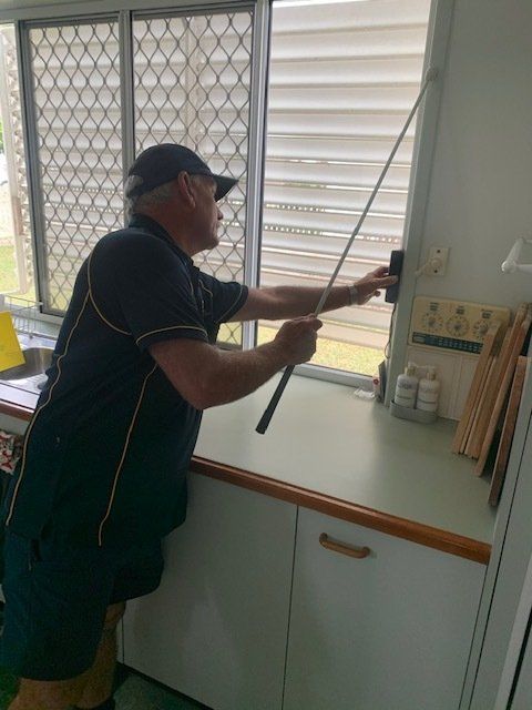 Technician Conducting a Termite Inspection in a the Kitchen—Termite Inspection Sunshine Coast QLD